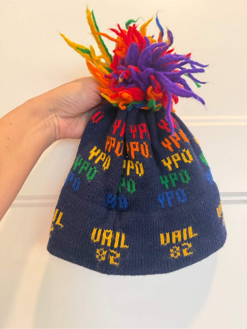 The Mountain Navy Knit Kids Beanie with Rainbow Pom Pom